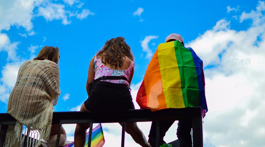 stock photo pride young people sitting on fence