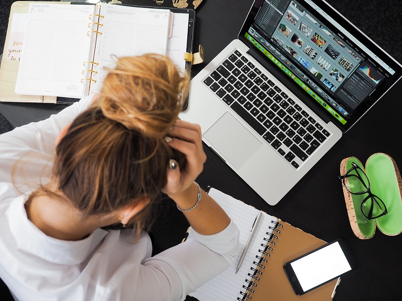 stock photo of girl haning over desk